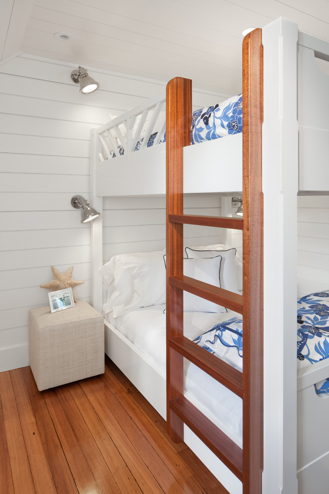 Mid-sized beach style guest medium tone wood floor bedroom photo in Providence with white walls