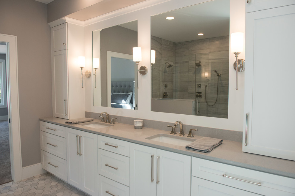 Example of a huge transitional master porcelain tile and gray floor freestanding bathtub design with shaker cabinets, white cabinets, a one-piece toilet, gray walls, an undermount sink, quartz countertops and gray countertops