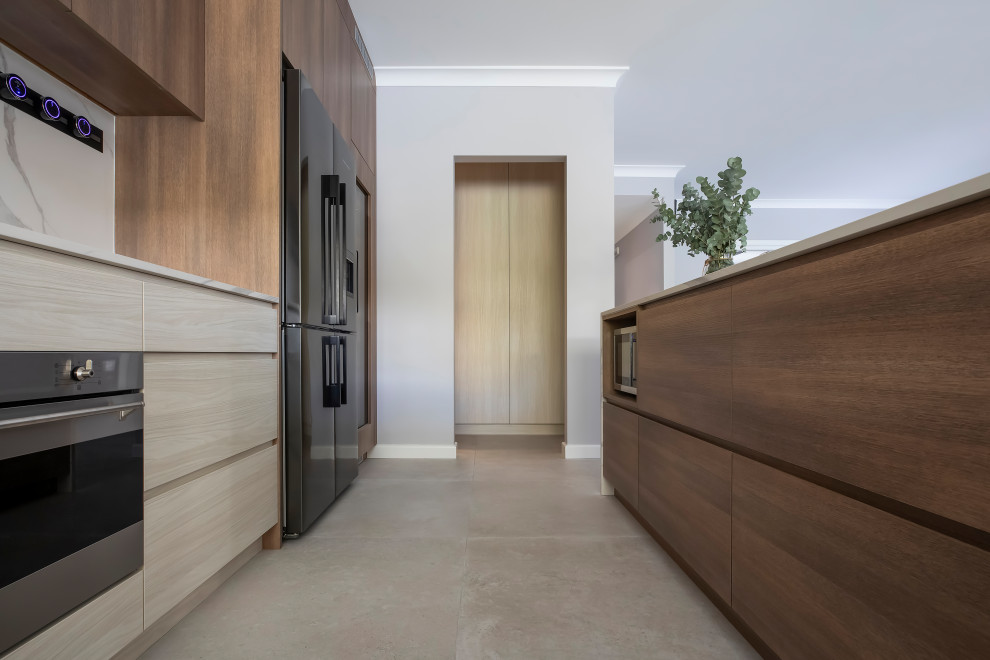 Inspiration for a large scandinavian l-shaped open plan kitchen in Sydney with an undermount sink, flat-panel cabinets, solid surface benchtops, white splashback, porcelain splashback, black appliances, porcelain floors, with island, grey floor and white benchtop.