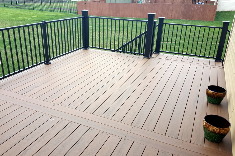 Example of a large backyard deck design with a pergola