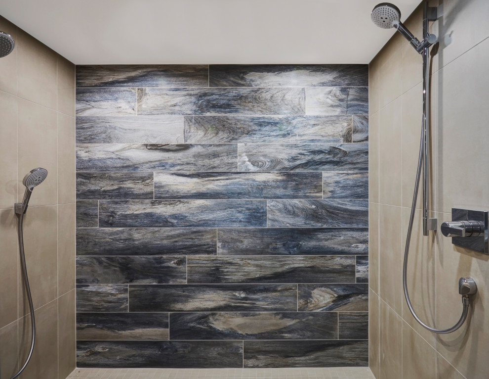 Large transitional master gray tile and porcelain tile double-sink, pebble tile floor and multicolored floor alcove shower photo with recessed-panel cabinets, gray cabinets, quartz countertops, a hinged shower door, gray countertops, a built-in vanity, a two-piece toilet, gray walls and an undermount sink