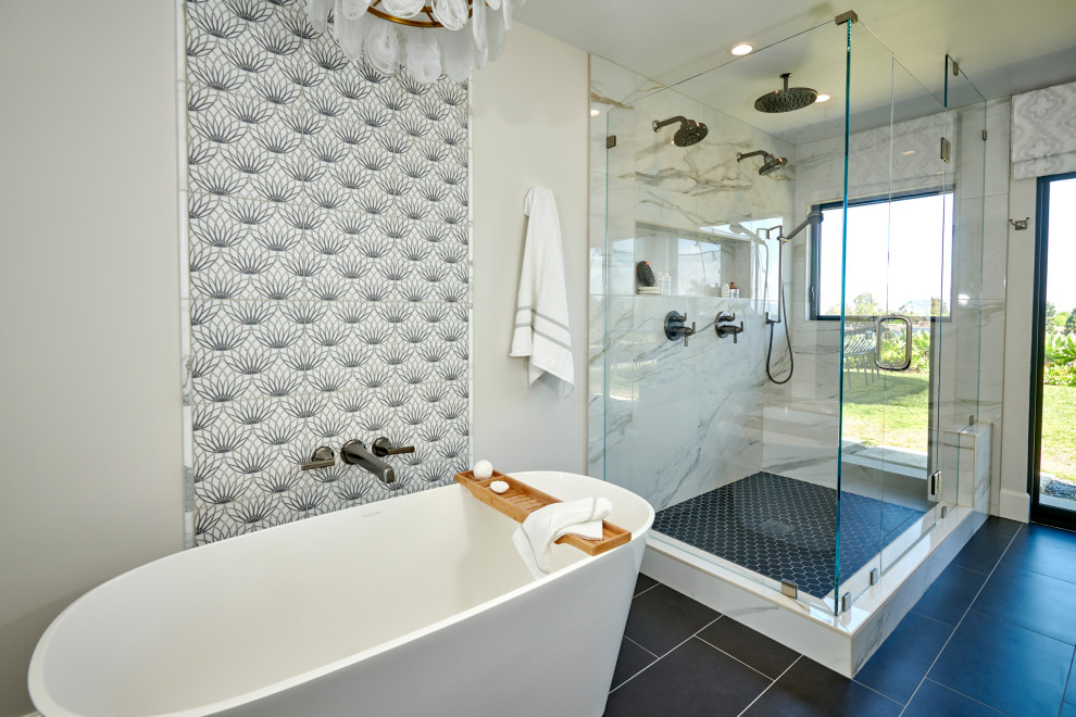 This is an example of a large master bathroom in Denver with recessed-panel cabinets, light wood cabinets, a freestanding tub, an alcove shower, a one-piece toilet, white tile, porcelain tile, white walls, porcelain floors, an undermount sink, engineered quartz benchtops, black floor, a hinged shower door, white benchtops, a niche, a double vanity, a built-in vanity and wallpaper.