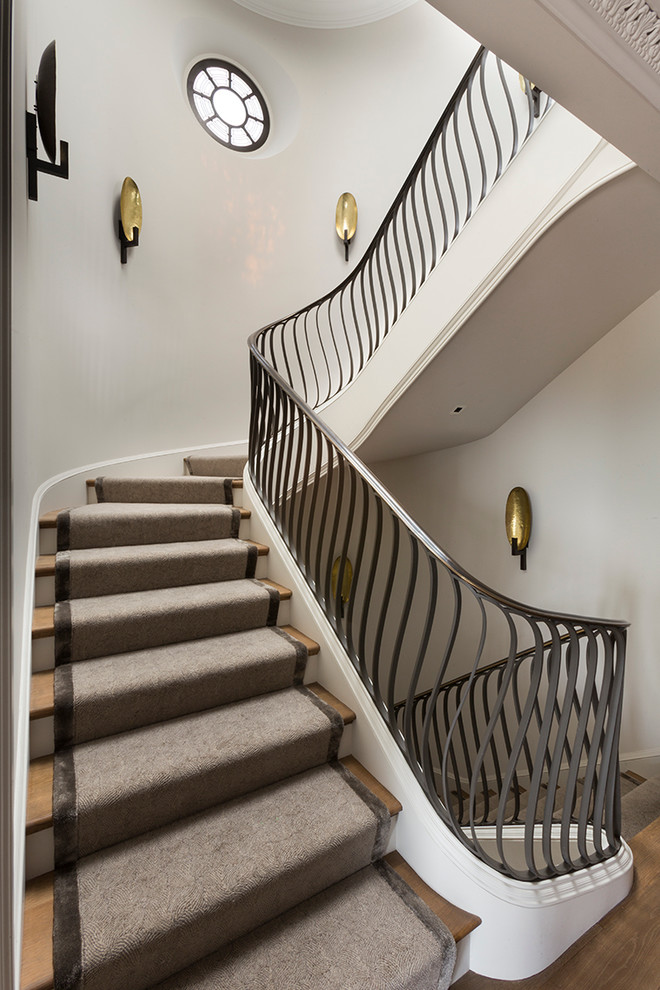 Photo of a transitional wood staircase in San Francisco with painted wood risers.