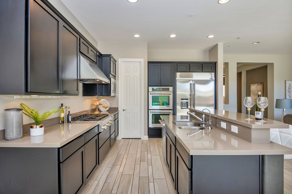 Mid-sized transitional galley ceramic tile and gray floor kitchen pantry photo in Phoenix with an undermount sink, quartz countertops, stainless steel appliances and an island