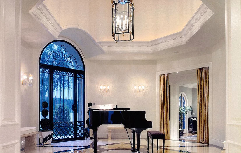 This is an example of a large traditional foyer in Los Angeles with white walls, travertine floors, a single front door, a glass front door and beige floor.
