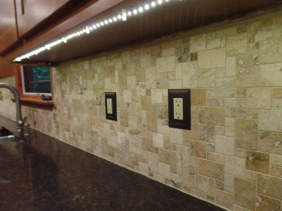 Example of a mid-sized transitional galley home design design with an undermount sink, shaker cabinets, medium tone wood cabinets, quartz countertops, multicolored backsplash, travertine backsplash, colored appliances and no island