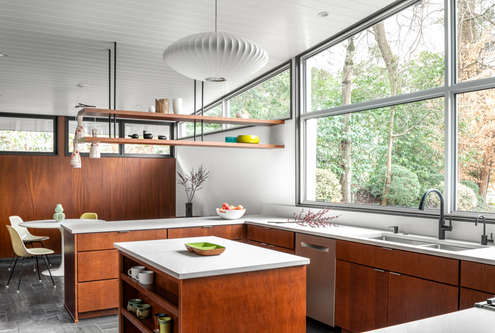 Inspiration for a midcentury u-shaped kitchen in Atlanta with an undermount sink, flat-panel cabinets, medium wood cabinets, with island, grey floor and white benchtop.