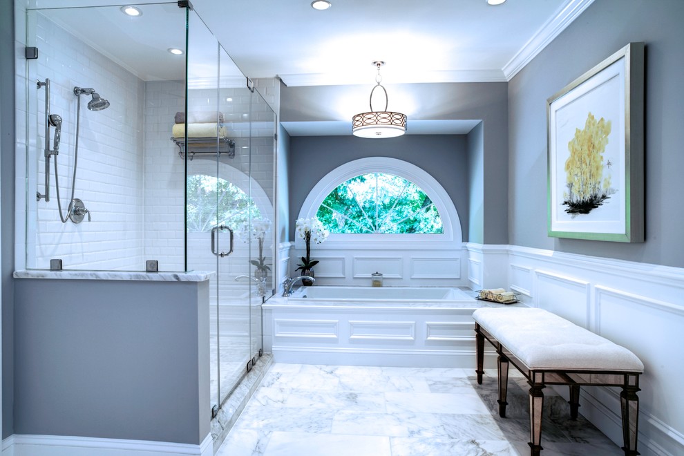 Example of a large transitional master white tile and subway tile marble floor alcove bathtub design in DC Metro with raised-panel cabinets, white cabinets, gray walls, an undermount sink and marble countertops
