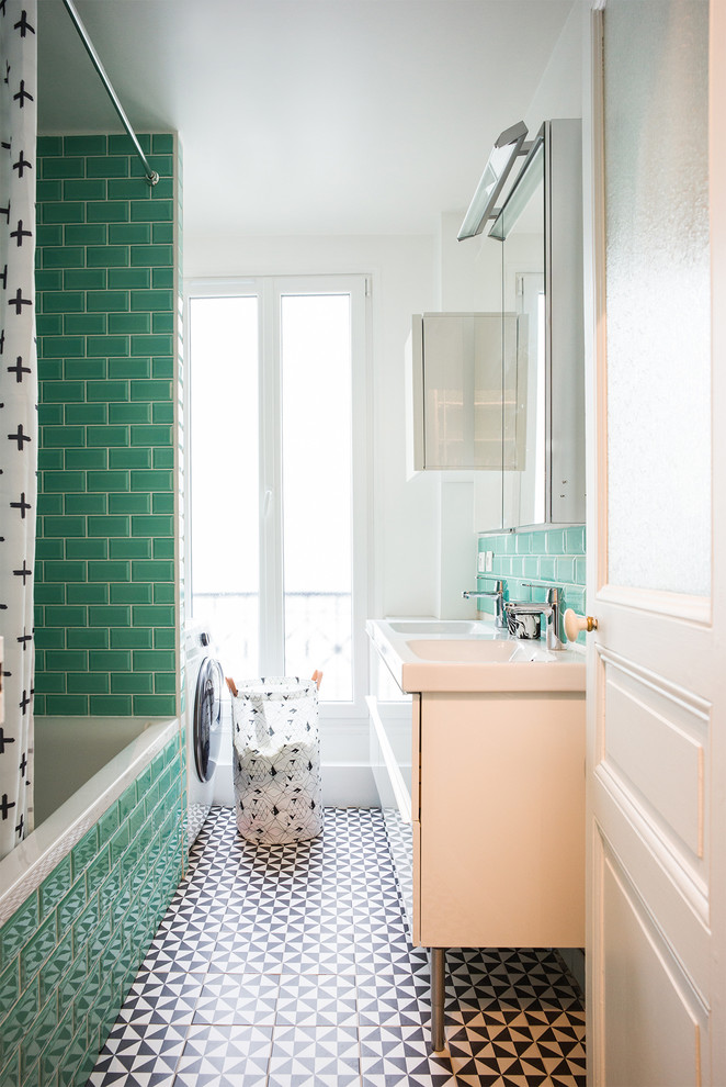 This is an example of a contemporary bathroom in Paris with flat-panel cabinets, white cabinets, a drop-in tub, a shower/bathtub combo, green tile, subway tile, white walls, a console sink, multi-coloured floor and a shower curtain.