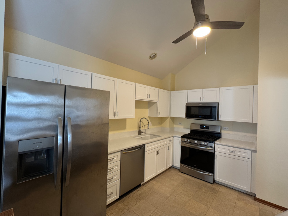 Inspiration for a mid-sized transitional l-shaped enclosed kitchen remodel in Chicago with shaker cabinets, white cabinets, quartz countertops and white countertops