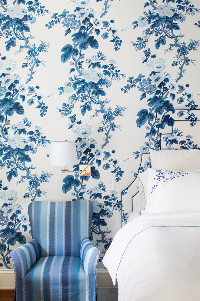 Transitional master bedroom in New York with blue walls, medium hardwood floors, brown floor and wallpaper.