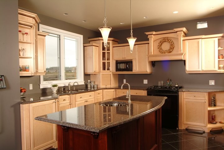 Kitchen pantry - mid-sized transitional l-shaped porcelain tile and black floor kitchen pantry idea in Toronto with granite countertops, an island, recessed-panel cabinets, light wood cabinets, gray backsplash, black appliances and a double-bowl sink