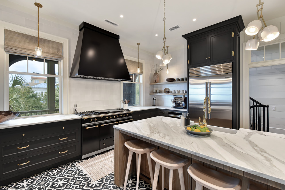 Design ideas for a mid-sized country l-shaped separate kitchen in Charleston with a farmhouse sink, recessed-panel cabinets, black cabinets, marble benchtops, grey splashback, subway tile splashback, stainless steel appliances, cement tiles, with island, multi-coloured floor and white benchtop.