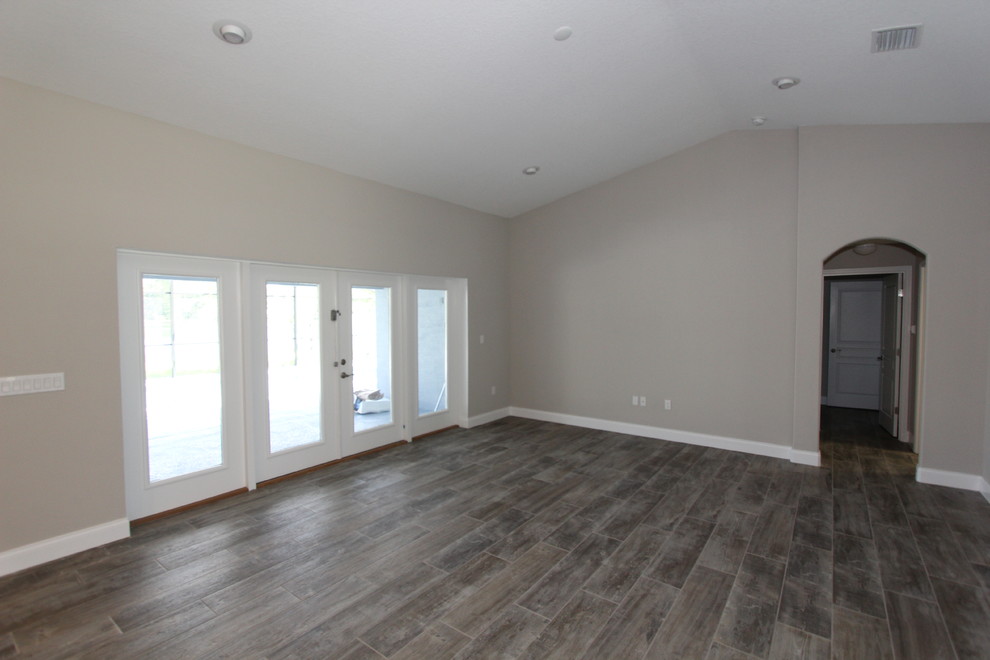 Photo of a mid-sized transitional open plan dining in Orlando with beige walls, porcelain floors and grey floor.