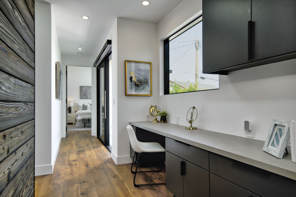 Example of a small trendy medium tone wood floor, brown floor and shiplap wall hallway design in San Francisco with white walls
