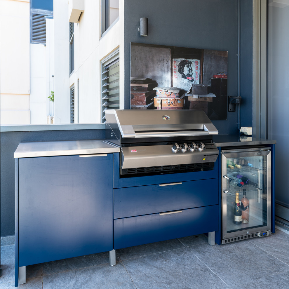 Inspiration for a small contemporary balcony in Sydney with a pergola and glass railing.