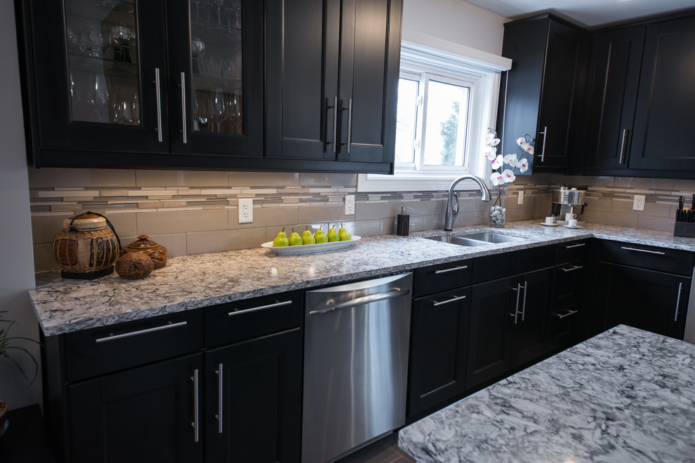 Inspiration for a transitional porcelain tile eat-in kitchen remodel in Ottawa with an undermount sink, recessed-panel cabinets, quartz countertops, glass tile backsplash and stainless steel appliances