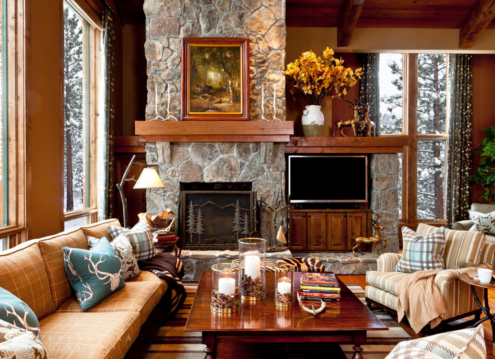 Photo of a country formal loft-style living room in Orange County with brown walls, medium hardwood floors, a built-in media wall, a standard fireplace and a stone fireplace surround.