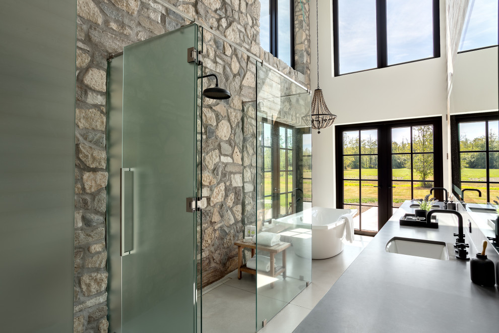 Design ideas for a large contemporary master bathroom in Vancouver with brown cabinets, a freestanding tub, grey walls, concrete floors, an undermount sink, wood benchtops, grey floor, black benchtops, a single vanity, a floating vanity and vaulted.