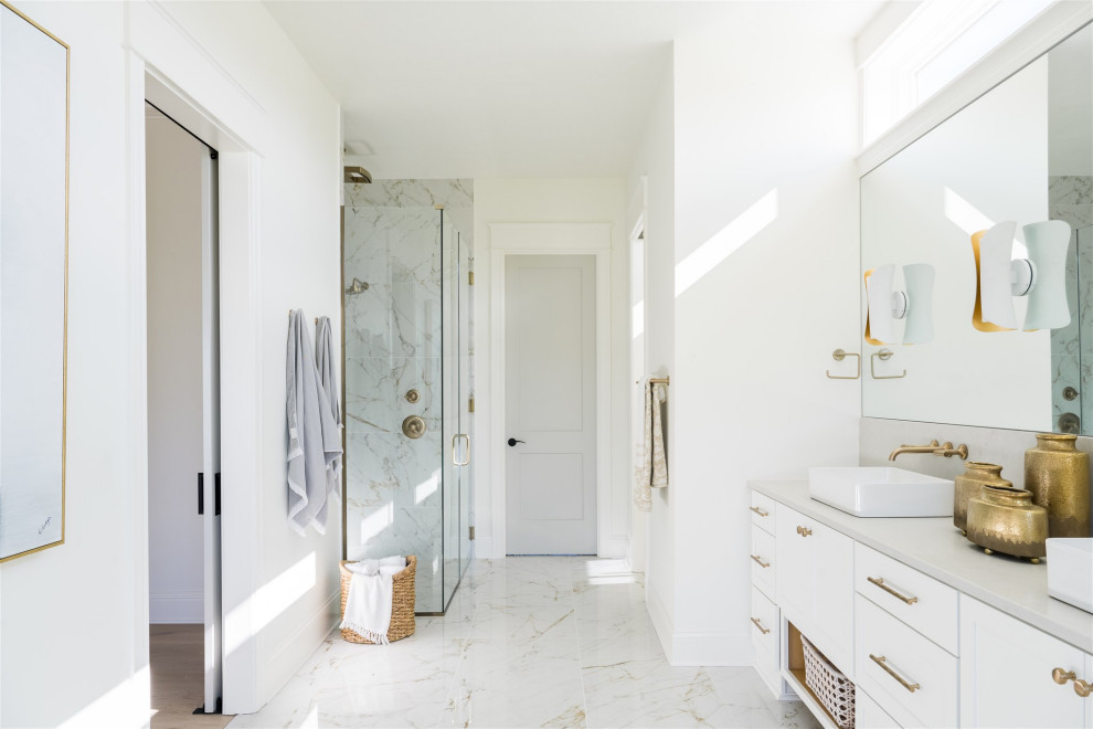 This is an example of a mid-sized beach style master wet room bathroom in Indianapolis with shaker cabinets, white cabinets, a corner tub, white walls, marble floors, a vessel sink, engineered quartz benchtops, white benchtops, a double vanity and a built-in vanity.