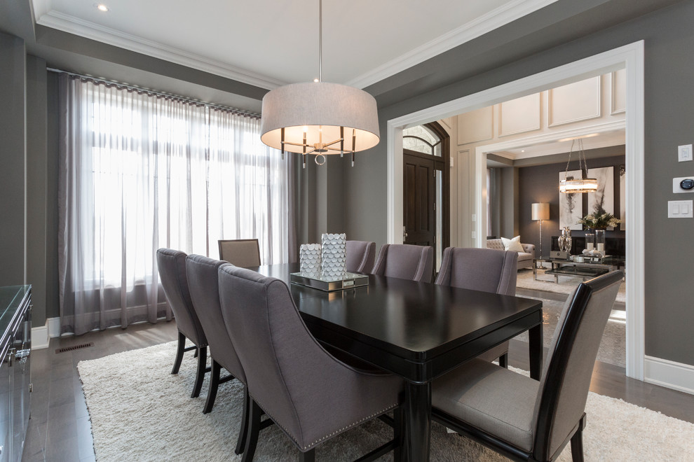 Transitional separate dining room in Toronto with grey walls and dark hardwood floors.