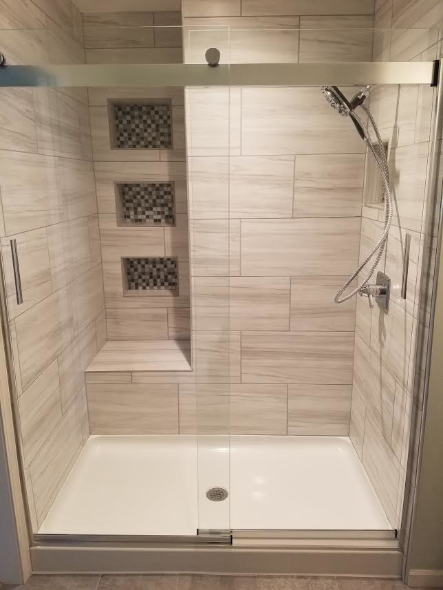 This is an example of a mid-sized traditional 3/4 bathroom in Other with an alcove shower, gray tile, porcelain tile and a sliding shower screen.