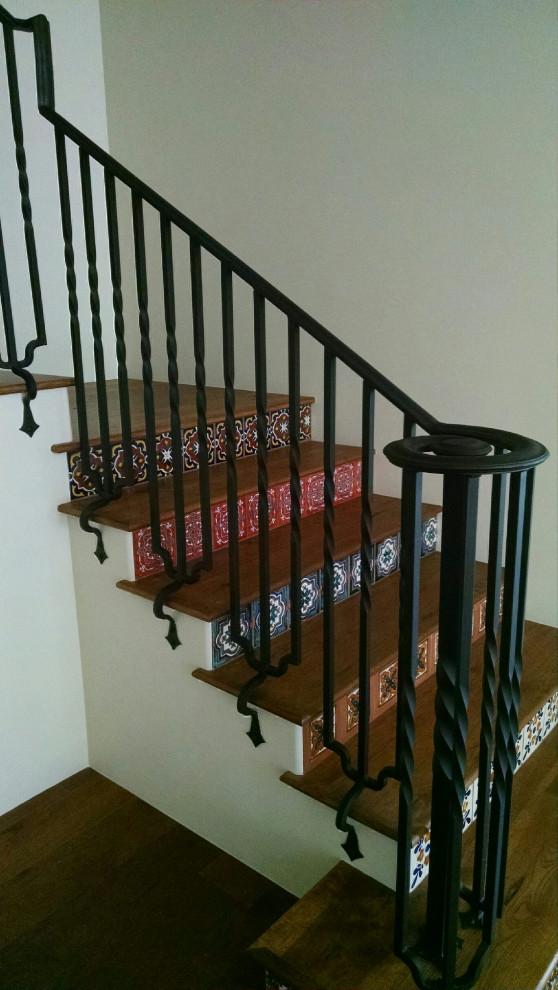 Transitional wooden l-shaped metal railing staircase photo in Phoenix with tile risers