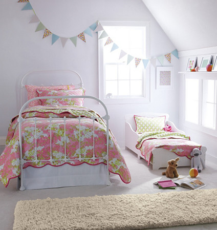 This is an example of a contemporary kids' bedroom for girls in Burlington with white walls and carpet.