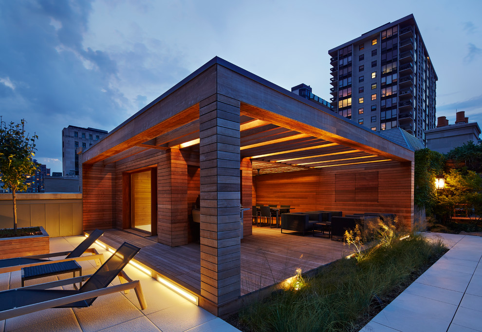 Photo of a contemporary rooftop deck in Chicago with an outdoor kitchen and a pergola.