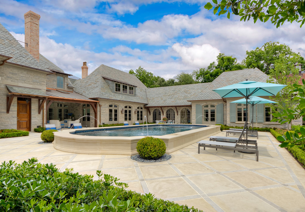 Photo of a traditional custom-shaped pool in Dallas with a water feature.