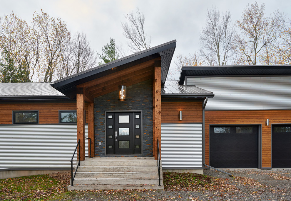 Design ideas for a large contemporary one-storey grey exterior in Toronto with mixed siding and a shed roof.