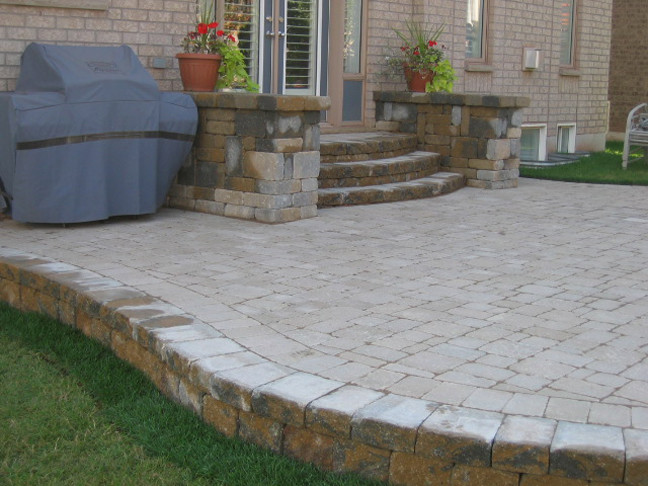 Inspiration for a transitional backyard brick landscaping in Toronto.
