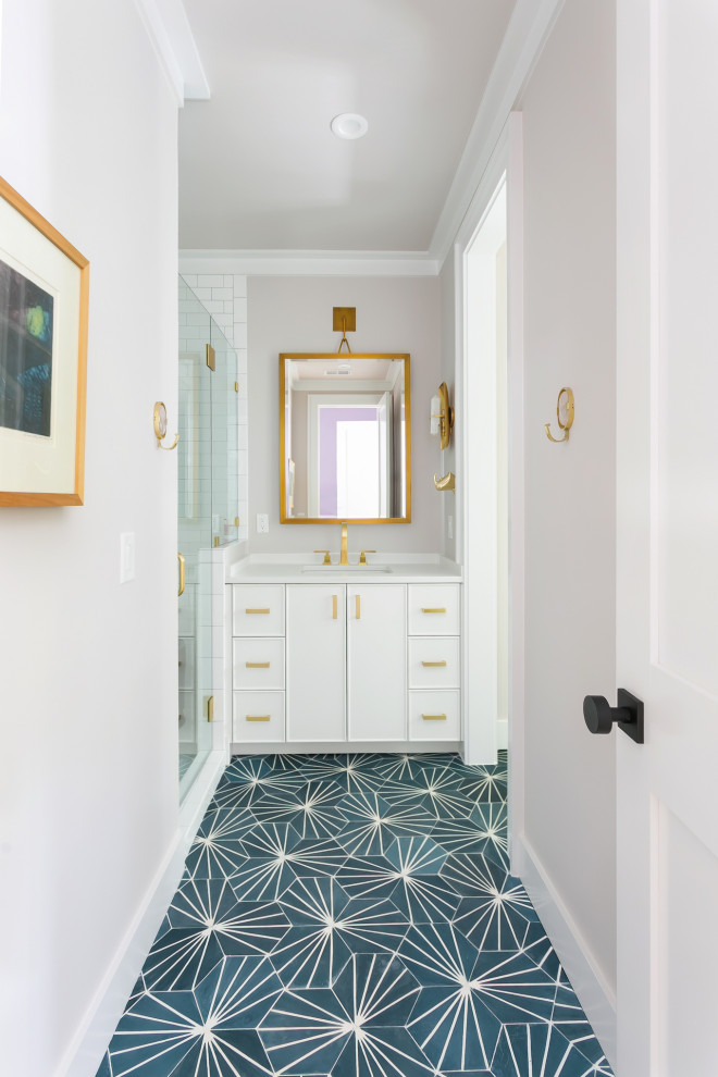 Transitional white tile cement tile floor, blue floor and single-sink alcove shower photo in Charleston with flat-panel cabinets, white cabinets, gray walls, an undermount sink, a hinged shower door and a built-in vanity