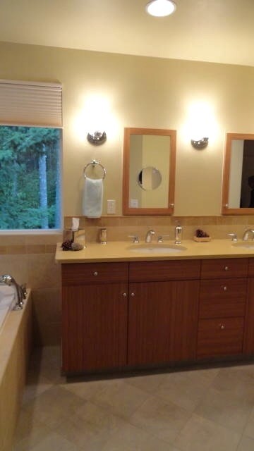 This is an example of a large modern master bathroom in Seattle with flat-panel cabinets, medium wood cabinets, an alcove tub, an alcove shower, yellow tile, porcelain tile, yellow walls, porcelain floors, an undermount sink and engineered quartz benchtops.