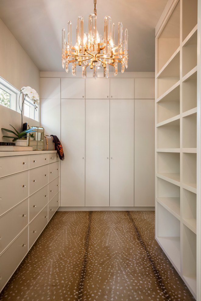 Large midcentury gender-neutral walk-in wardrobe in Portland with flat-panel cabinets, white cabinets and carpet.