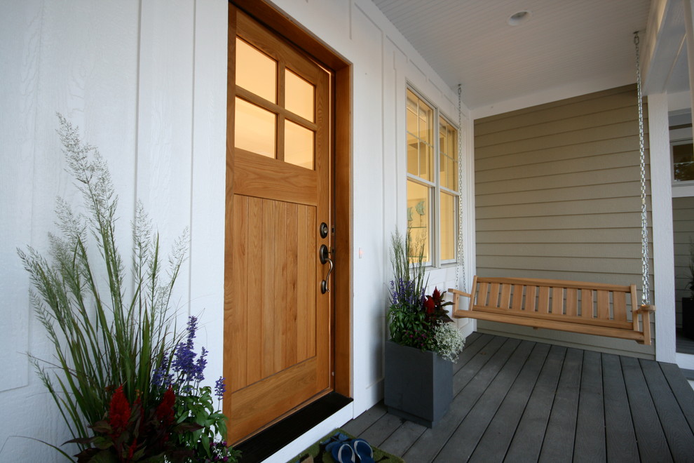 Beach style entryway in Grand Rapids with a single front door and a medium wood front door.