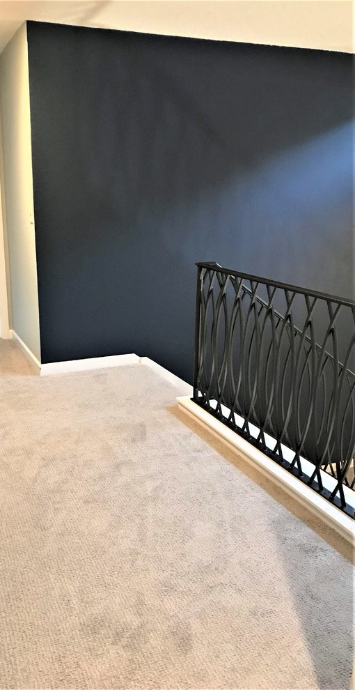 Mid-sized transitional carpeted u-shaped metal railing staircase photo in Seattle with carpeted risers