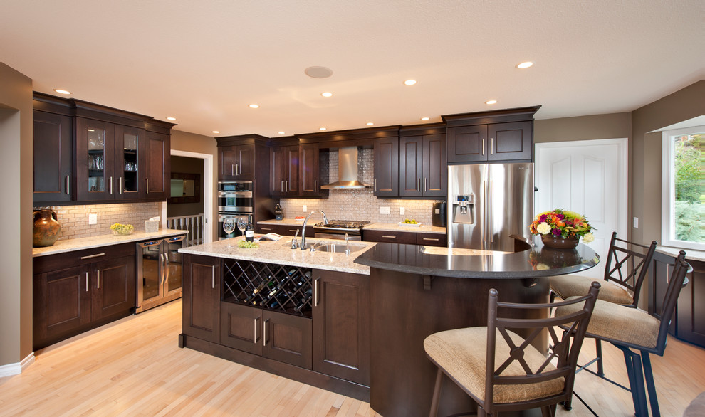 Large u-shaped light wood floor eat-in kitchen photo in Vancouver with an undermount sink, recessed-panel cabinets, dark wood cabinets, glass tile backsplash, stainless steel appliances and an island