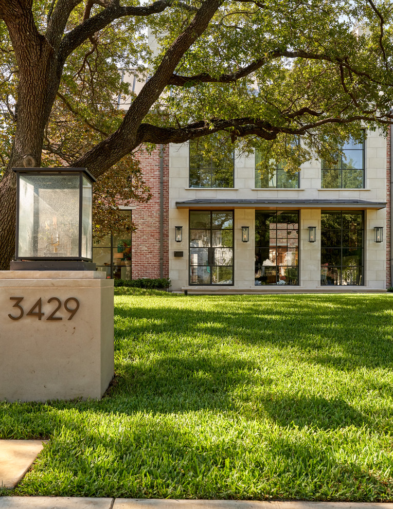 Beverly | 2018 - Inspiration for a large transitional brown two-story brick gable roof remodel in Dallas with a metal roof