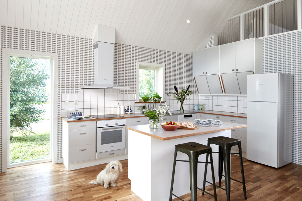 This is an example of a midcentury l-shaped open plan kitchen in Gothenburg with with island.