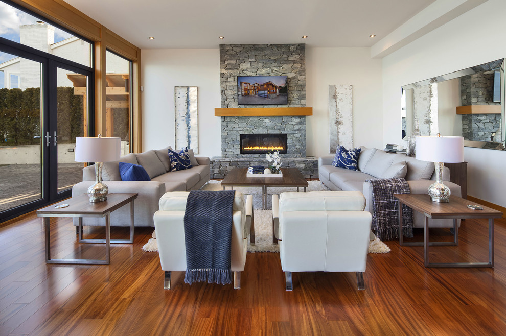 Mid-sized contemporary formal open concept living room in Vancouver with white walls, dark hardwood floors, a ribbon fireplace, a stone fireplace surround and no tv.