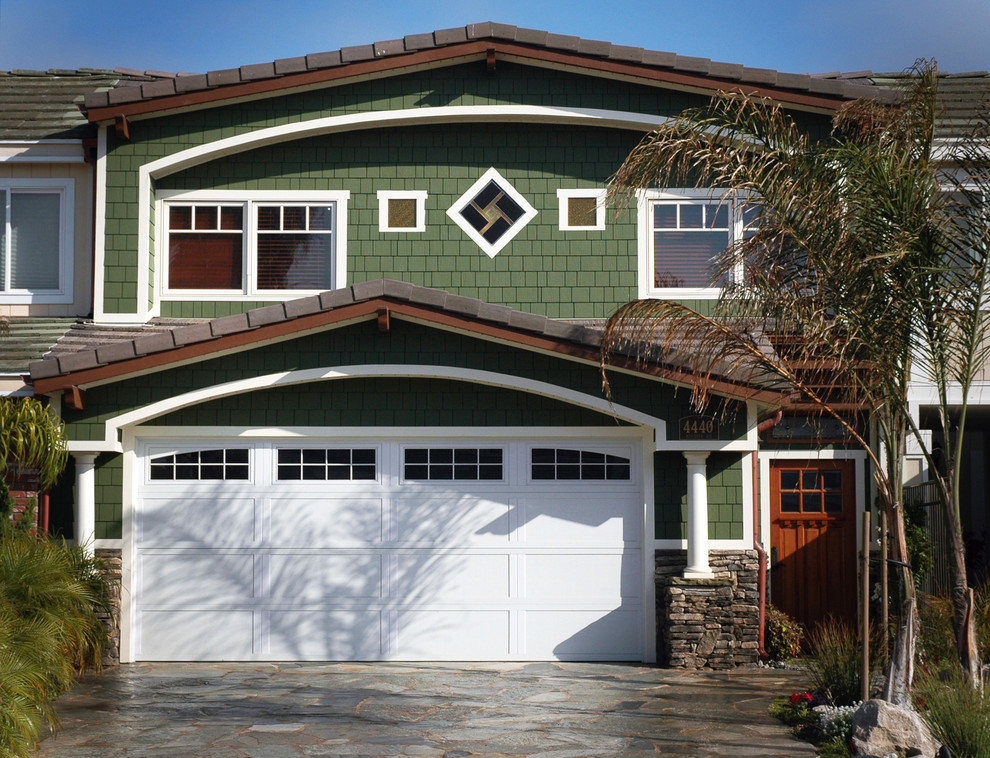 Photo of a mid-sized arts and crafts two-storey green exterior in Los Angeles with wood siding and a gable roof.