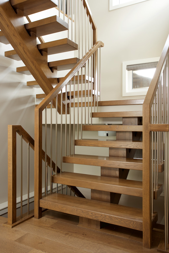 Photo of a contemporary wood floating staircase in Edmonton with open risers and mixed railing.