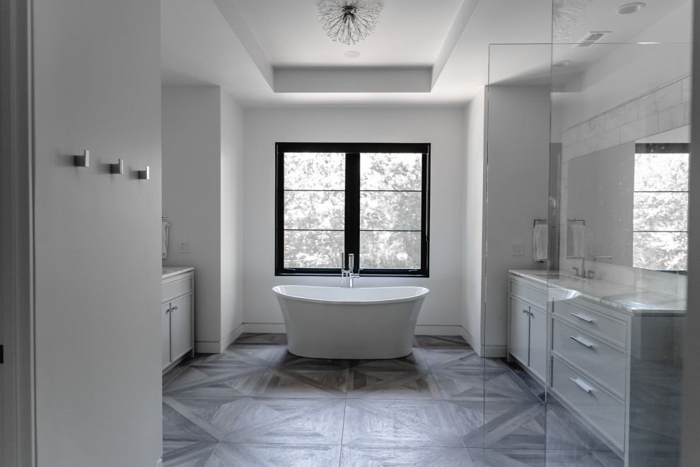 Photo of a country master bathroom in Chicago with flat-panel cabinets, grey cabinets, a freestanding tub, an open shower, white tile, marble, porcelain floors, an undermount sink, marble benchtops, grey floor, an open shower and white benchtops.