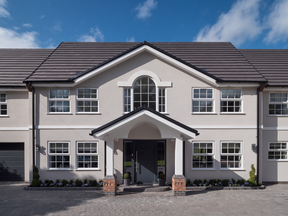 Design ideas for a large and gey modern detached house in West Midlands with mixed cladding, a pitched roof and a tiled roof.