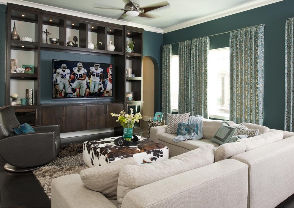Contemporary family room in Dallas with blue walls and a built-in media wall.