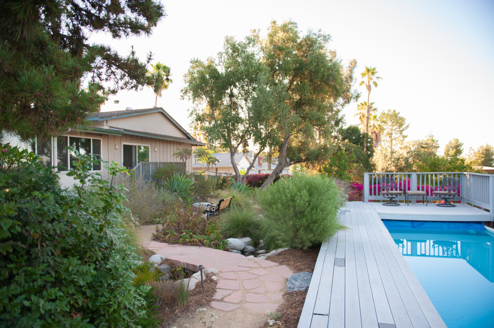 Expansive eclectic backyard rectangular lap pool in Los Angeles with with a pool and decking.