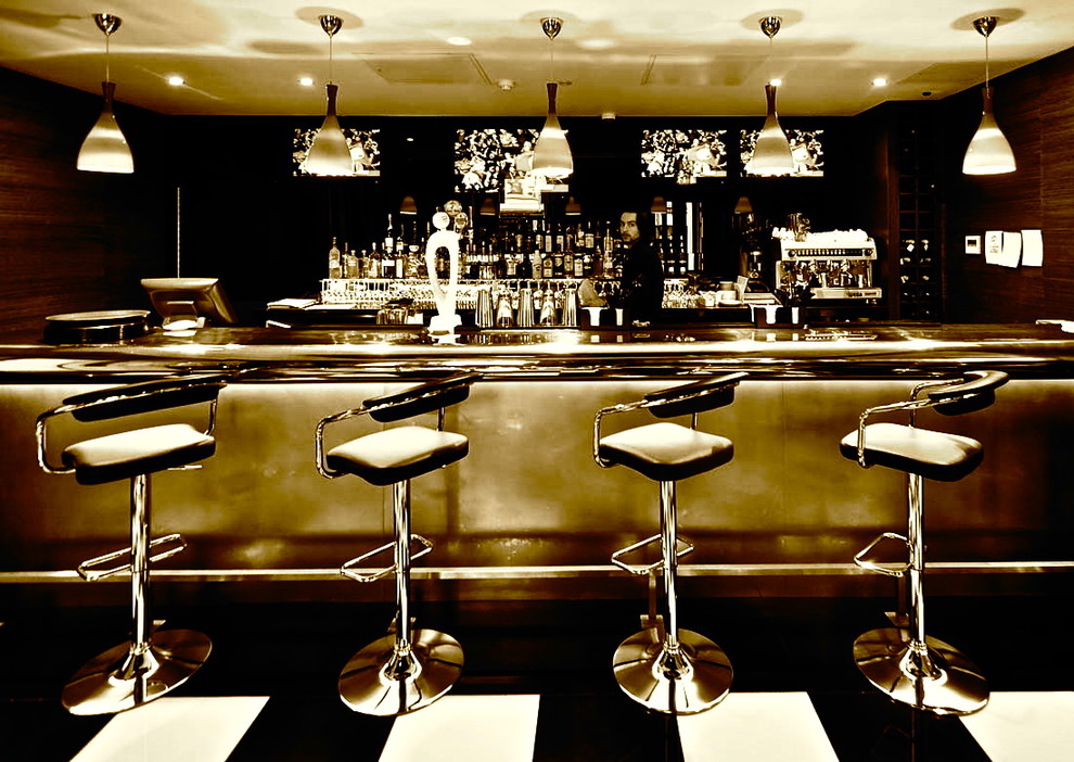 Example of a trendy home bar design in London