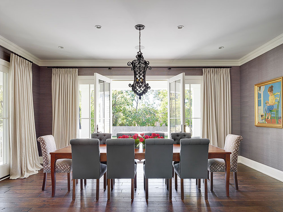 This is an example of a transitional dining room in Chicago with grey walls and dark hardwood floors.