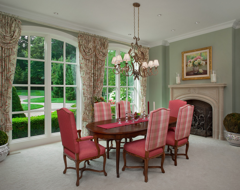 Large traditional separate dining room in Grand Rapids with green walls, carpet and a standard fireplace.